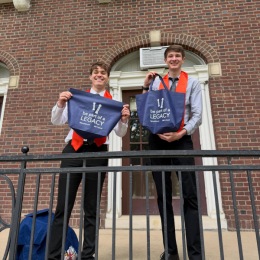 two young men holding bags